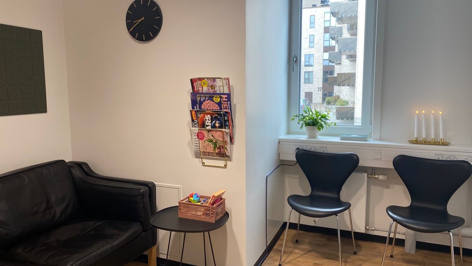 Venteværelset hos Privat Psykiatrisk Center Aalborg med lædersofaer og udsigt til Eternitkvarteret