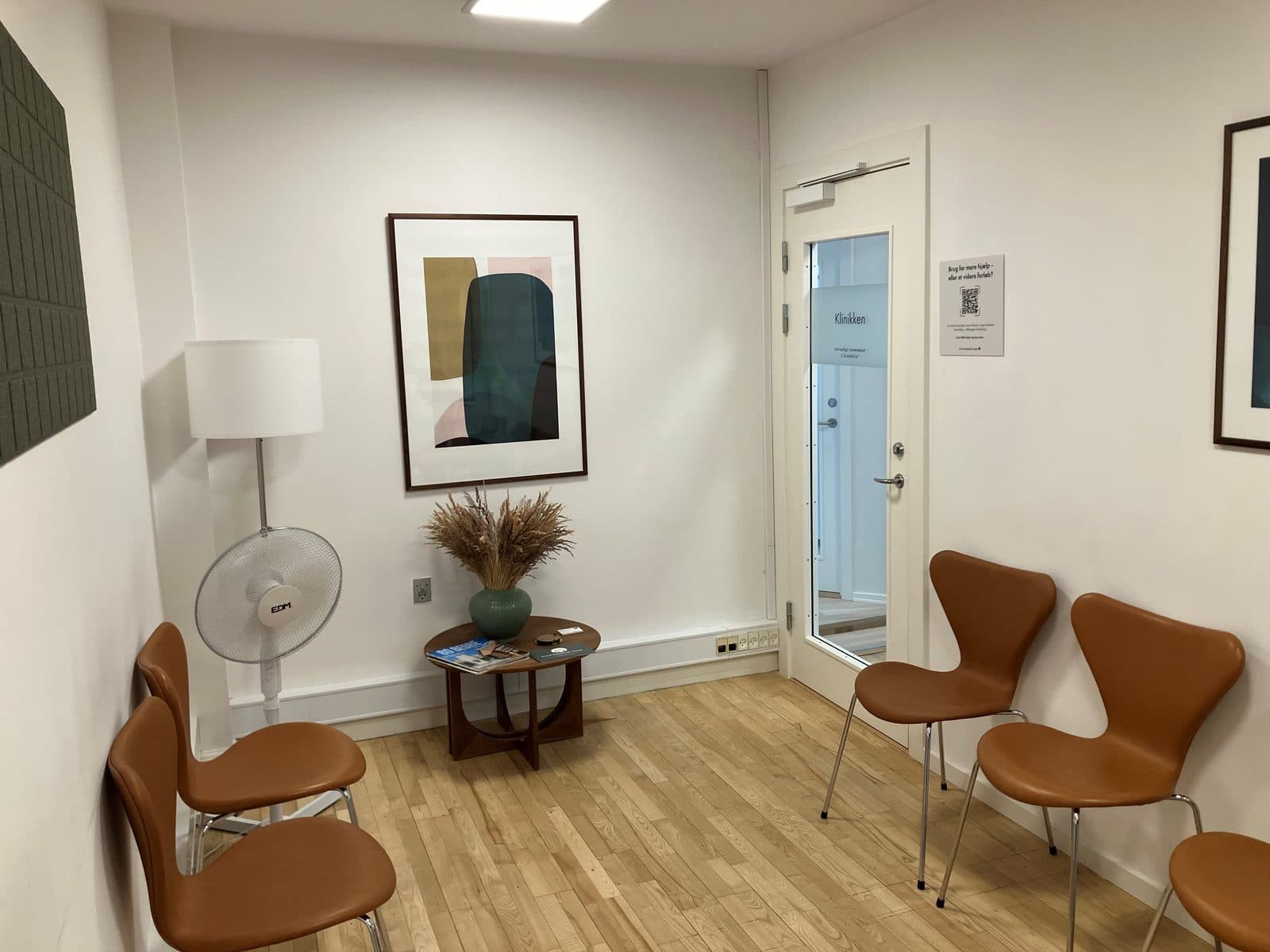Venteværelse hos Privat Psykiatrisk Center Lyngby med lædestole og kunst på væggen